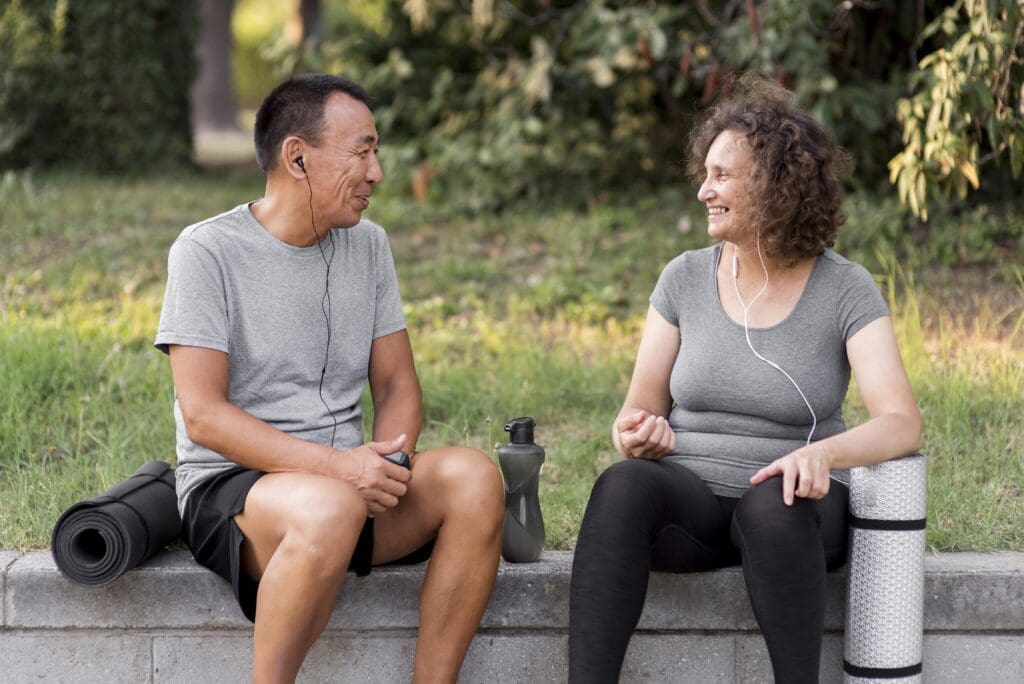 Mid age man and woman taking a break from exercise