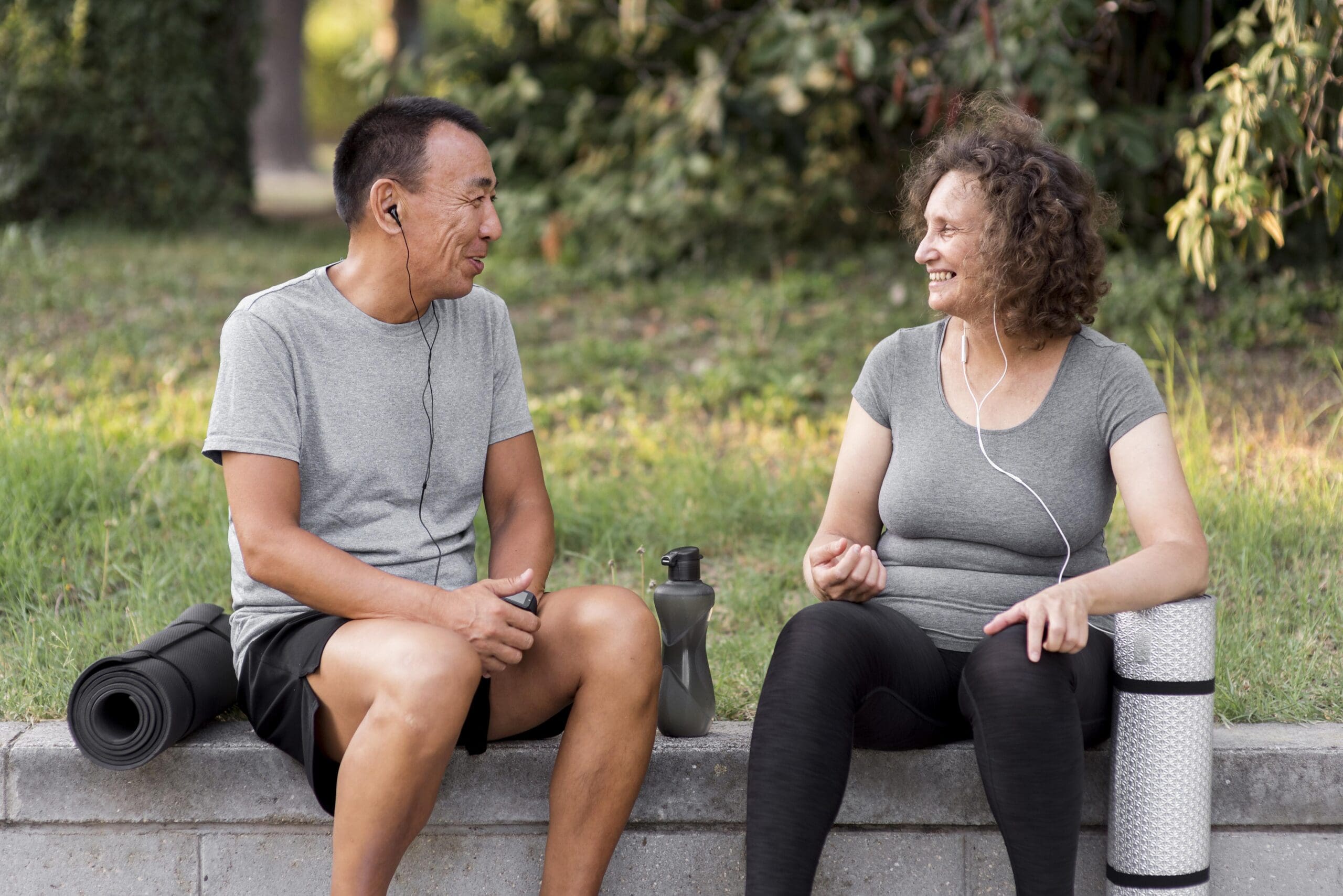 Mid age man and woman taking a break from exercise