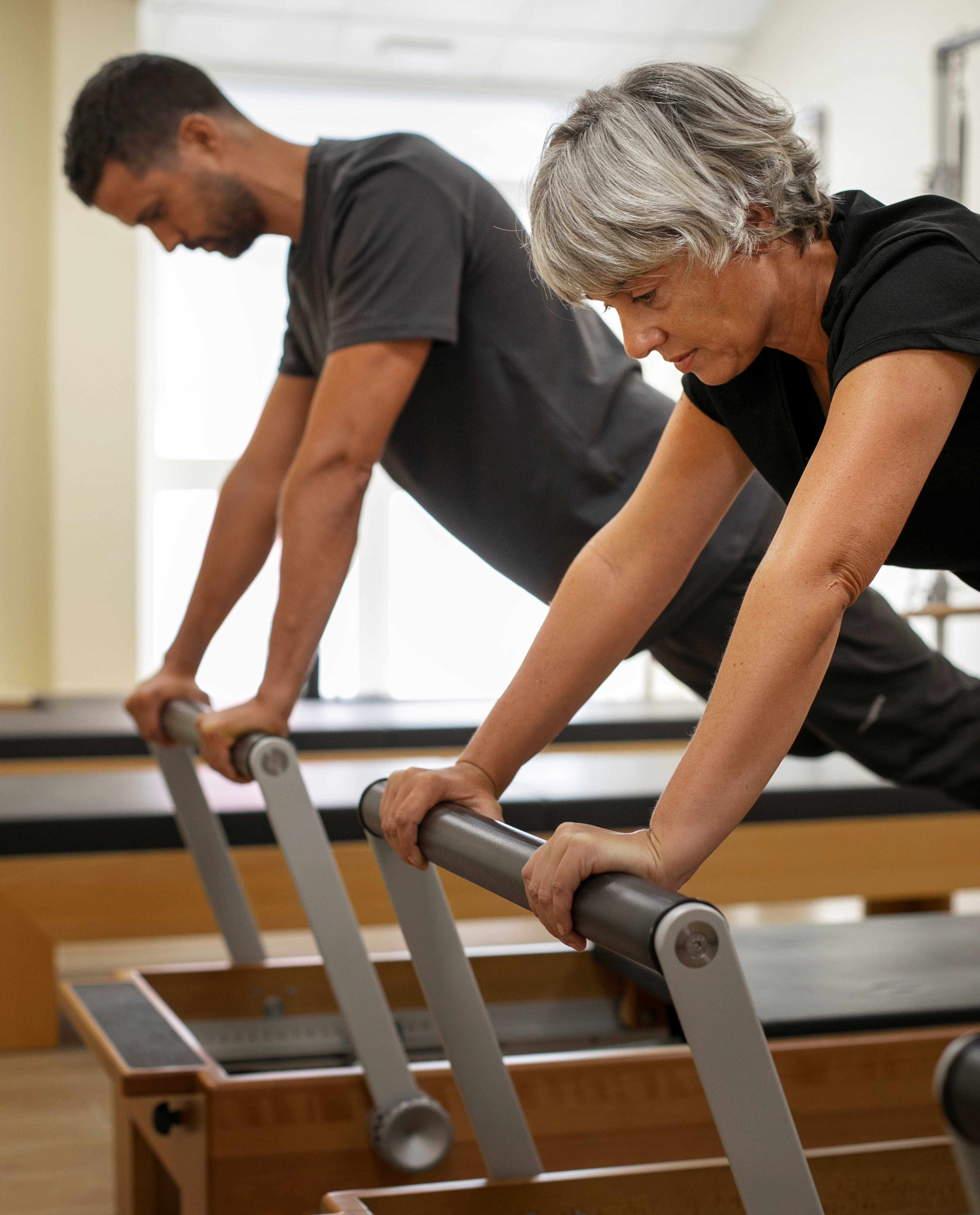 Side view of an old man and woman having thread mill